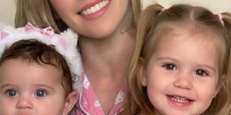 Young woman puts both daughters inside the ..